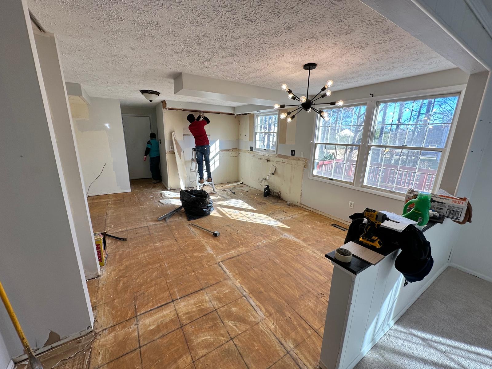 Before — crew removing walls and old finishes during the kitchen demolition