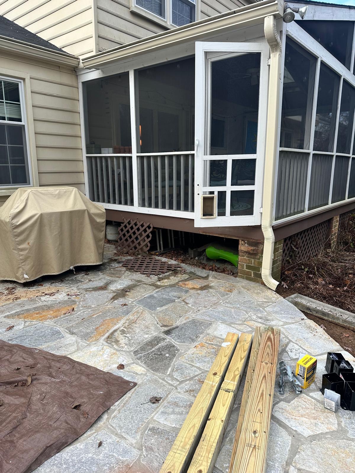 Before — screened porch entry with worn lattice and no stairs